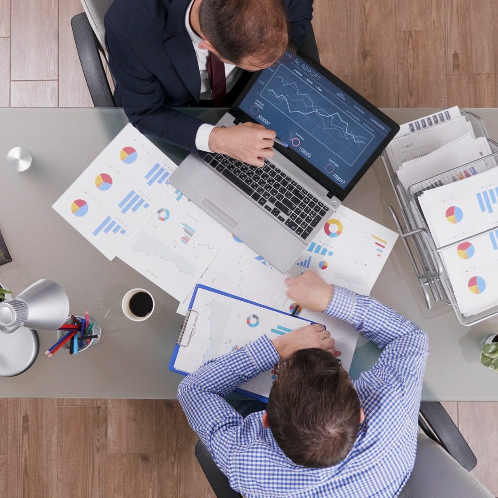 top-view-of-businessmen-analyzing-management-statistics-while-working-at-company-investments.jpg Tax Preparation